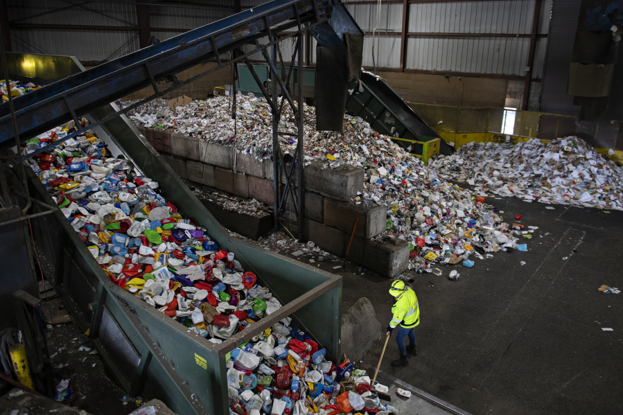Crews sort recyclables at West Van Material Recovery Center in November 2023. The state&rsquo;s ban on single-use plastic bags appears to be having little impact on reducing plastic coming into landfills and recycling centers. (Amanda Cowan/The Columbian files)