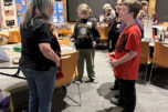 Author Dawn Shipman, left, speaks with student Joshua Sloop and Washougal School District highly capable coordinator Kathlynn Sloop during the Washougal School District&rsquo;s Night with the Authors event Nov. 12 at Washougal High School. (Contributed by the Washougal School District)