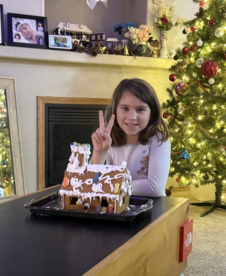 Shelbie McQueen poses for a photo after completing a gingerbread house earlier this month. (Contributed by Tiesha McQueen)