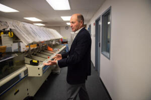 Clark County Elections Office ballot processing is underway as election day approaches. 
 Clark County Auditor, Greg Kimsey, shows off a ballot sorting machine at the Elections Office.