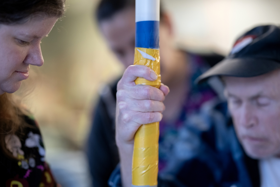 Ellie Landa, from left, and Melissa Allmaras of Vancouver Specialty and Rehabilitation Care assist resident Danny Ellefson on Dec. 4. (Amanda Cowan/The Columbian)