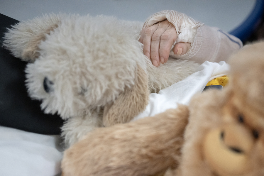 A resident at Vancouver Specialty and Rehabilitation Care cuddles with soft and fuzzy friends while watching a Christmas movie Dec. 4.
