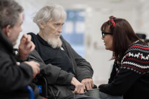 Richard Kalmbach, from left, and Robert Mullan pause to chat in the hallway with regional health services liaison Dianna Kretzschmar at Vancouver Specialty and Rehabilitation Care on Dec. 4. (Amanda Cowan/The Columbian)