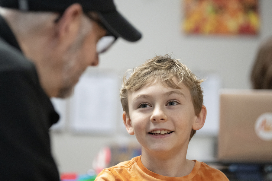 Reading mentor Lee Campen, left, works with third-grader Kellin Bartholomew, 8, during the Read Northwest program at Hathaway Elementary School on Dec. 8. From sounding out words to reading chapter books, Clark County children are getting extra help with their reading through Vancouver nonprofit Read Northwest. (Amanda Cowan/The Columbian)