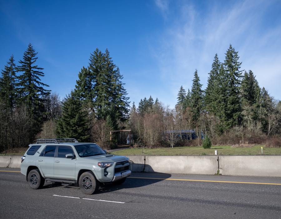 A car drives along state Highway 502 near Northeast 92nd Avenue on Monday near Battle Ground. The city of Battle Ground wants to annex agricultural lands into the city and rezone them for industrial development.