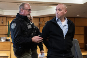 Former Camas-Washougal Fire Battalion Chief Kevin West, right, speaks to a member of the gallery as he is led away in handcuffs Tuesday after a jury found West guilty of the murder of his wife at the Clark County Courthouse. (Photos by Taylor Balkom/The Columbian)