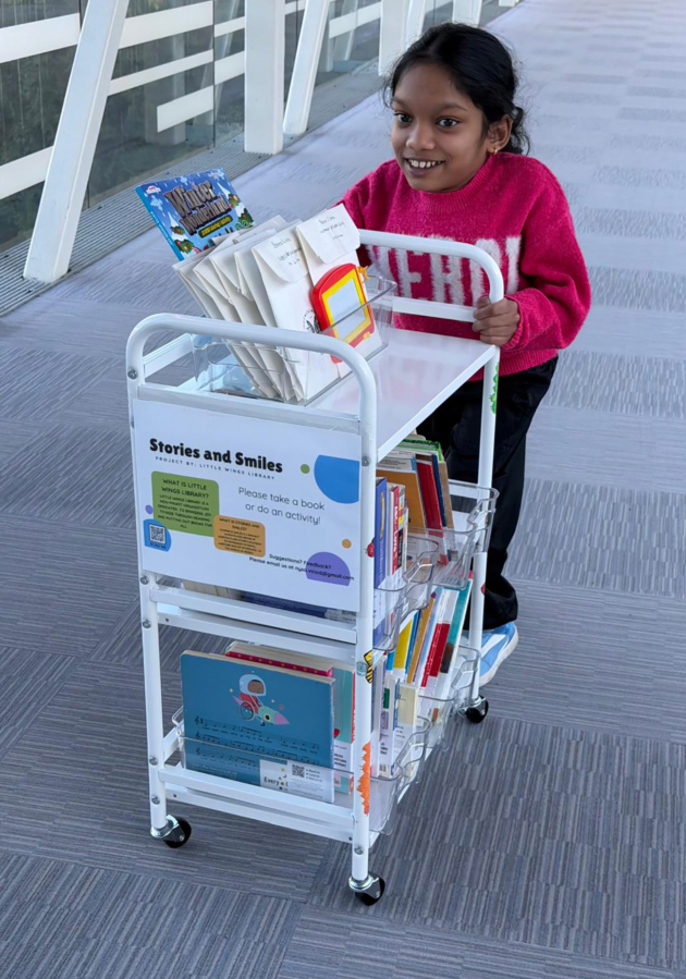 Nysa Vinod, a 14-year-old Camas eighth-grader, pushes one of her Stories and Smiles carts in an Evergreen Pediatrics Clinic location in Vancouver. (Vinod Vijayan)