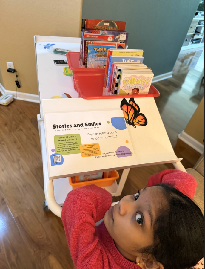 Nysa Vinod, a 14-year-old Camas eighth-grader, looks up from one of her Stories and Smiles carts. (Vinod Vijayan)