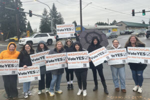 Washougal School District levy supporters wave signs at the intersection of 32nd Street and Evergreen Way in Washougal on Jan. 29. The district&rsquo;s two renewal levy proposals were passing as of early election returns Tuesday. (Contributed by Washougal Citizens For Schools)