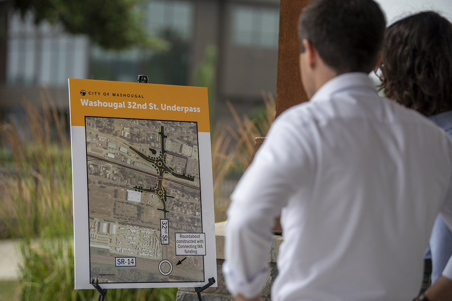 Then-U.S. Secretary of Transportation Pete Buttigieg, left, and U.S. Rep. Marie Gluesenkamp Perez look over a diagram of the Washougal 32nd Street underpass at the Port of Camas-Washougal on July 7, 2023. (Amanda Cowan/The Columbian files)