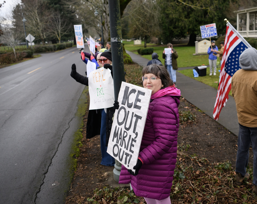 Rose Hart of Vancouver, center, joins others in a protest outside the offices of U.S. Rep. Marie Gluesenkamp Perez, D-Skamania, on Officers Row in the Fort Vancouver National Historic Site. People were protesting outside the representative&rsquo;s office every day last week. (Photos by Taylor Balkom/The Columbian)