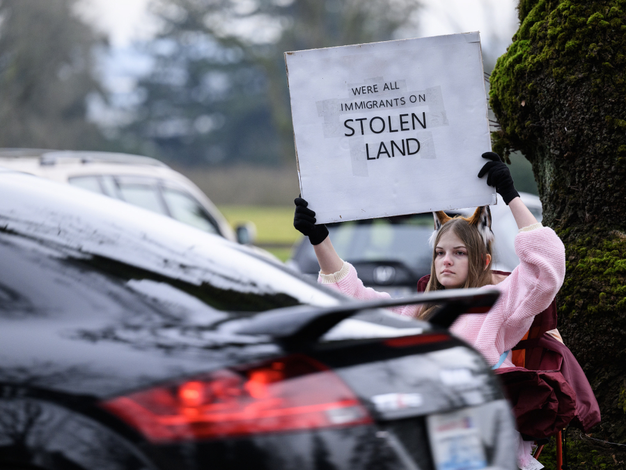 Taylor Balkom/The Columbian
Alice Haragan, 14, of Vancouver, holds a sign as traffic moves down Evergreen Boulevard on Wednesday, Jan. 28, 2026, outside the Vancouver offices of U.S. Rep. Marie Gluesenkamp Perez, D-Skamania. Haragan said she had joined the protest to represent youth who are concerned about what&rsquo;s happening on the national level, especially when it comes to violent immigration enforcement raids. &ldquo;There are just so many kids that are worried, and I felt like I should represent that,&rdquo; she said.