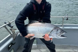Ocean salmon seasons will start in June. Here a happy angler shows off a fine chinook salmon taken with Sea Breeze Charters. (Photo courtesy Sea Breeze Charters)