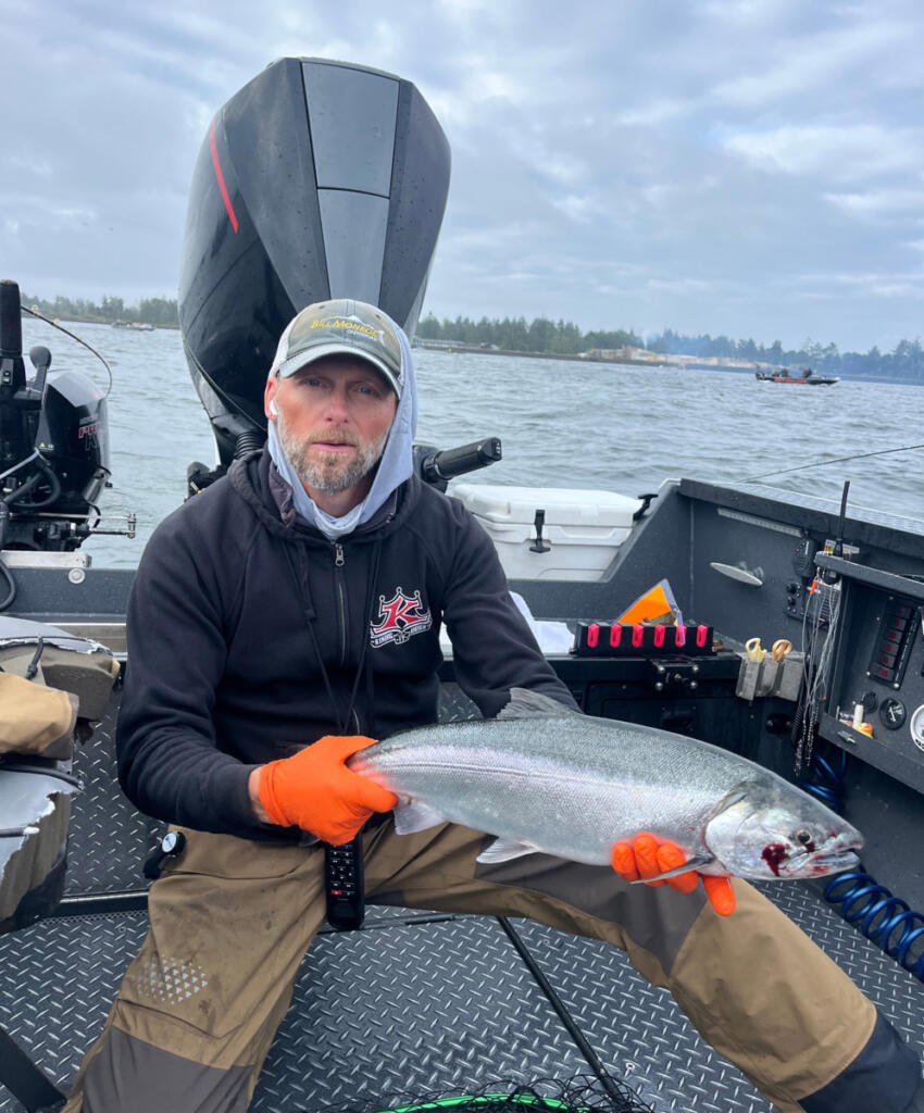 Fishing Guide Bill Monroe Jr., holds a fine, bright coho salmon taken during the Buoy 10 fishery last year. Anglers can expect in-river fisheries to be almost exactly the same as in 2025. (Photo courtesy Bill Monroe Outdoors)