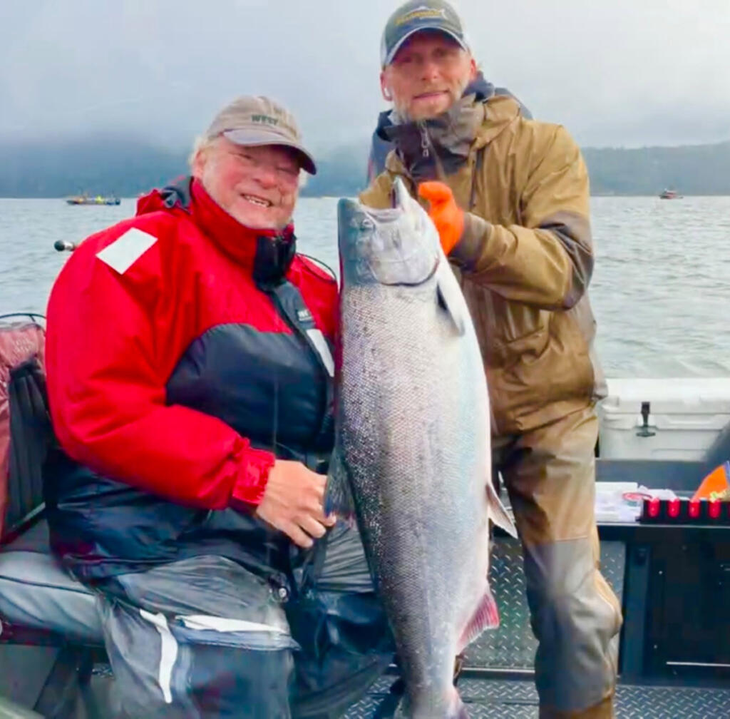 Guide Bill Monroe Jr., right, and a client with a Chinook salmon taken in the Buoy 10 fishery in 2025. The North of Falcon process is continuing, as fishery managers hash out all the ocean and river fisheries for the coming season. (Photo courtesy Bill Monroe Outdoors)