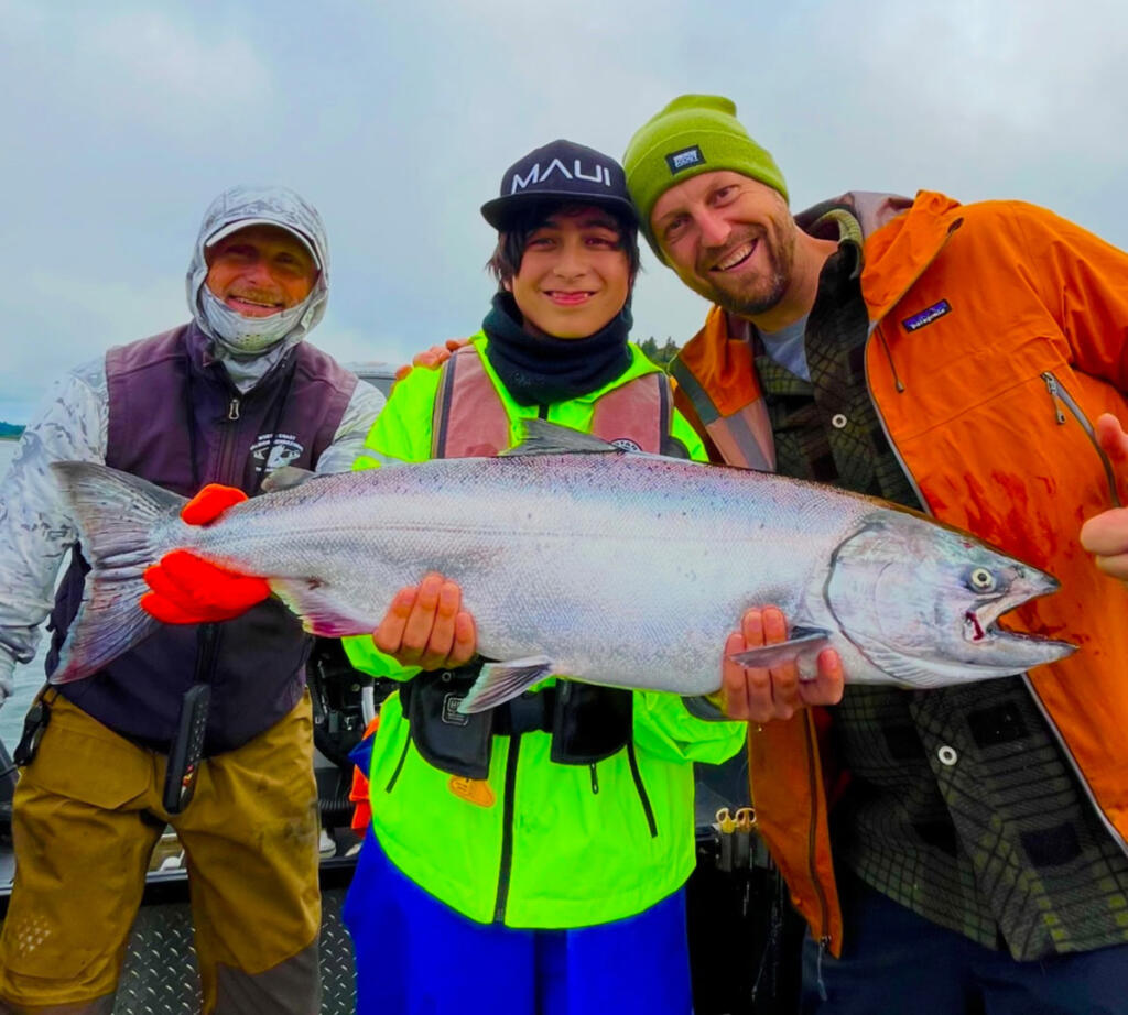 Smiles all the way around as happy anglers hold a chinook salmon taken last year in the Columbia River. If conditions in the river and ocean are good this year, anglers should enjoy a fine year for both ocean and river salmon. (Photo courtesy Bill Monroe Outdoors)
