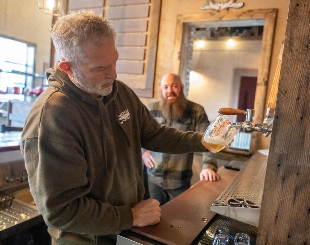 Owner and head brewer Rod Edwards, left, pours a beer while fellow owner and director of business opportunities Jon Borth watches at Shoug&rsquo;s Draft House in Washougal.
(Taylor Balkom/The Columbian)