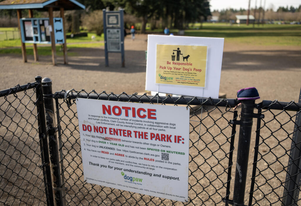 A sign at the entrance of Dakota Dog Park in Vancouver, seen here on Feb. 26, informs parkgoers about the importance of picking up after their pets. Pet waste left behind is an environmental and health hazard for local water sources. (Photos by Taylor Balkom/The Columbian)