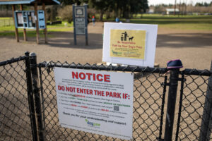 A sign at the entrance of Dakota Dog Park in Vancouver, seen here on Feb. 26, informs parkgoers about the importance of picking up after their pets. Pet waste left behind is an environmental and health hazard for local water sources. (Photos by Taylor Balkom/The Columbian)
