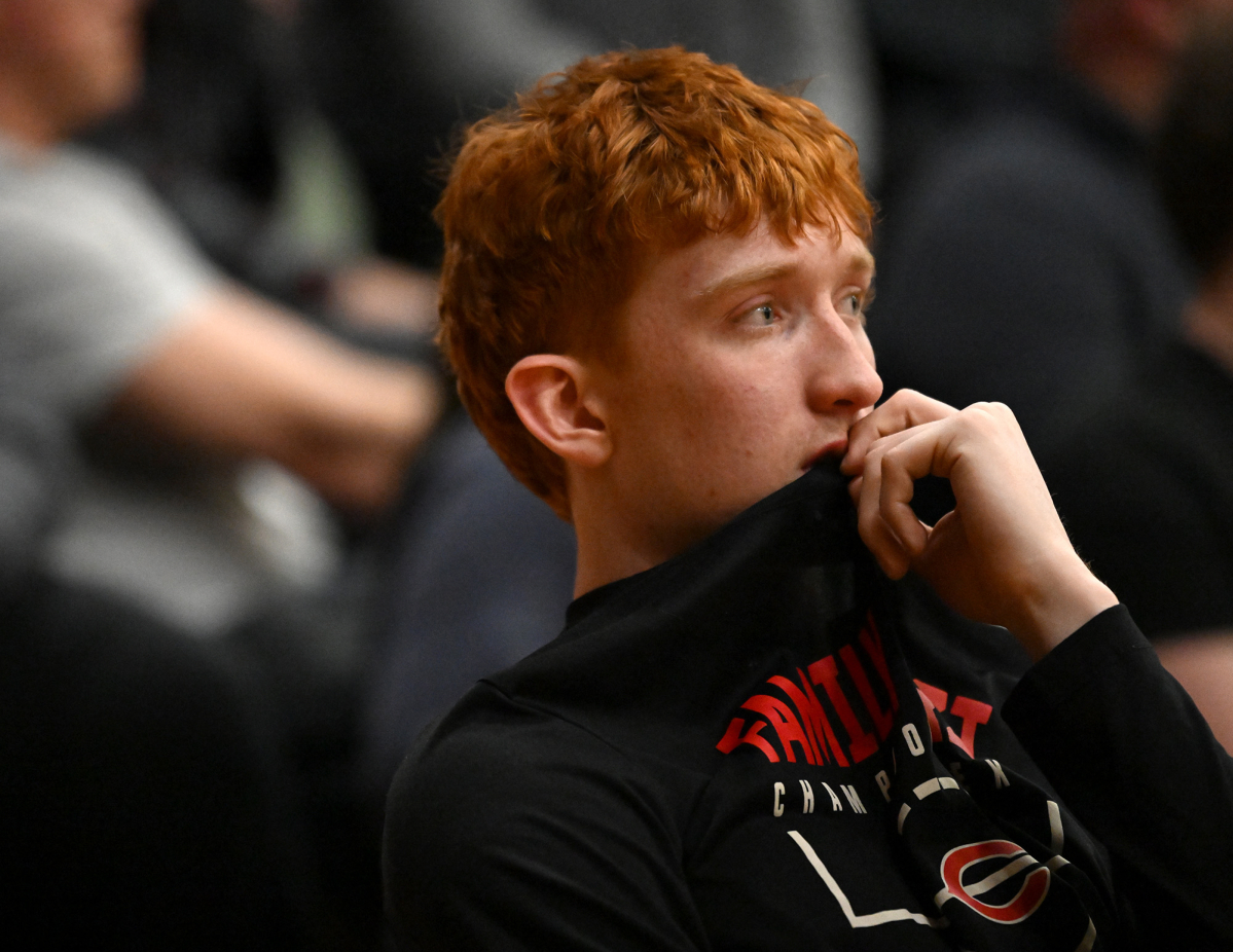 Camas senior Ethan Harris watches from the bench Friday, as a lingering foot injury kept him from playing. (Taylor Balkom/The Columbian)
