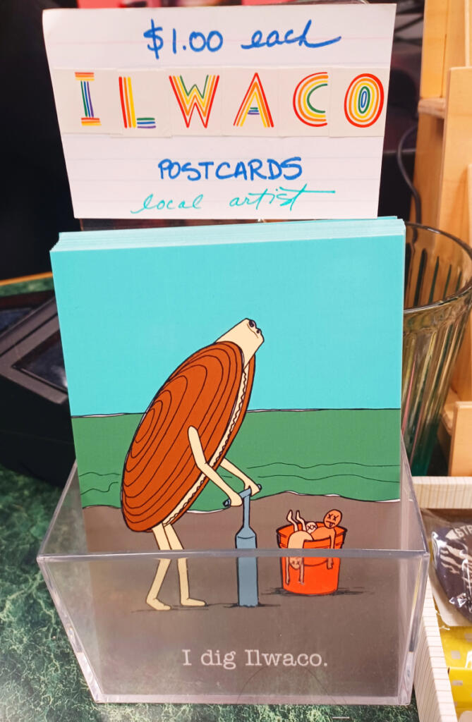 This postcard at Time Enough Books is a clever reminder of Ilwaco&rsquo;s local ocean bounty. (Monika Spykerman/The Columbian)