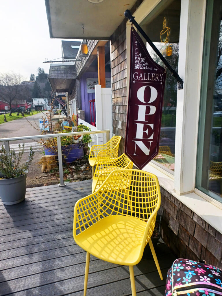 On sunny days, these bright yellow chairs invite guests to linger over lattes at 3 Otters Coffee. Inside, visitors will find art and products by local artisans. (Monika Spykerman/The Columbian)