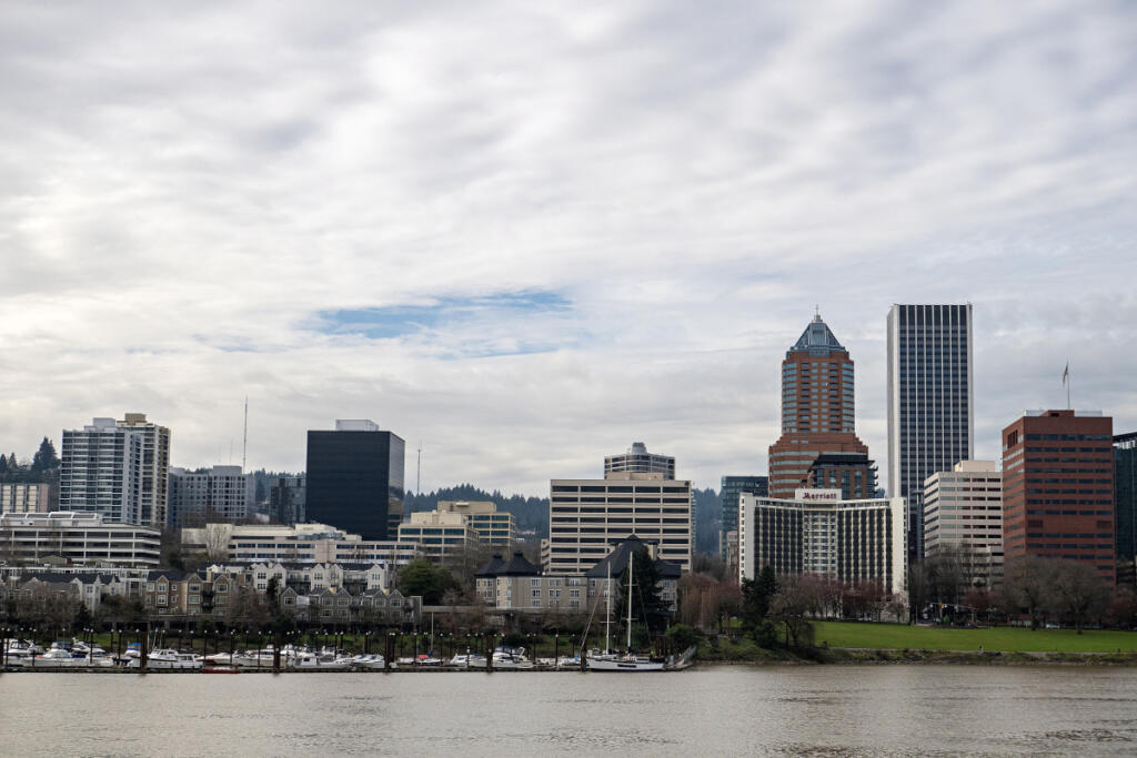 The Portland skyline is visible from the east side of the Willamette River on Tuesday afternoon. Recent data shows that in some pockets of Clark County, buyers are paying just as much or more for housing than in Portland. (Amanda Cowan/The Columbian)
