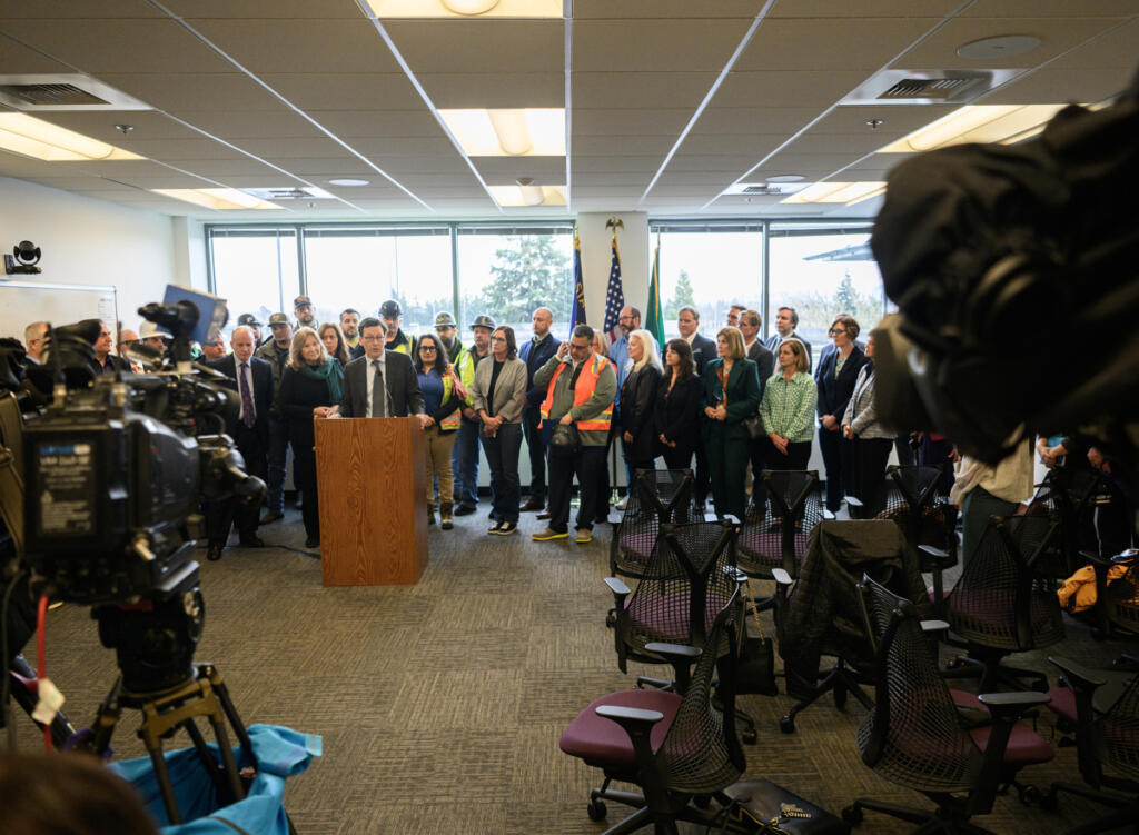 Washington Gov. Bob Ferguson, left, speaks at a press conference Tuesday at the Interstate Bridge Replacement Program headquarters in downtown Vancouver. (Taylor Balkom/The Columbian)