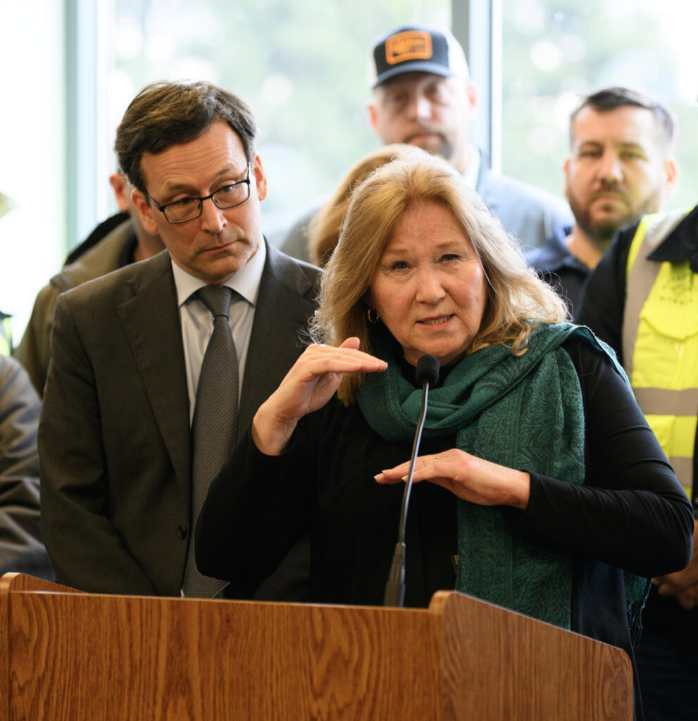 Vancouver Mayor Anne McEnerny-Ogle, right, answers a question from a reporter Tuesday, during a press conference at the Interstate Bridge Replacement Program headquarters in downtown Vancouver. (Taylor Balkom/The Columbian)