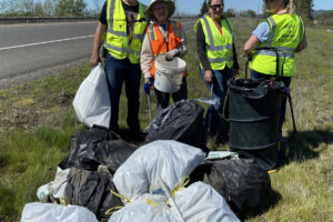 East County Citizens&rsquo; Alliance volunteers, including Mark Silliman, far left, pick up trash off the side of state Highway 14 in Clark County on April 29, 2023. (Photo contributed by Melanie Wilson)