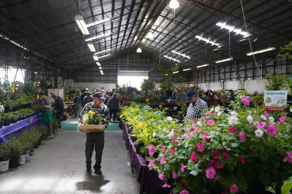 People explore the plant sale in 2019 at the Home and Garden Idea Fair hosted by Clark Public Utilities at the Clark County Fairgrounds. The event includes one of the largest plant sales in the area. (The Columbian file photos)