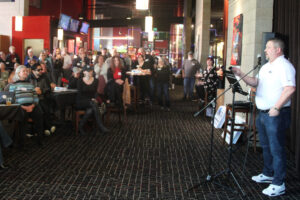 A crowd listens to Brent Hennrich, right, a Democratic candidate for Washington&rsquo;s 3rd Congressional District, during his campaign kickoff at the AMC Classic Mill Plain 8 cinema in Vancouver. (Kelly Moyer/The Columbian)