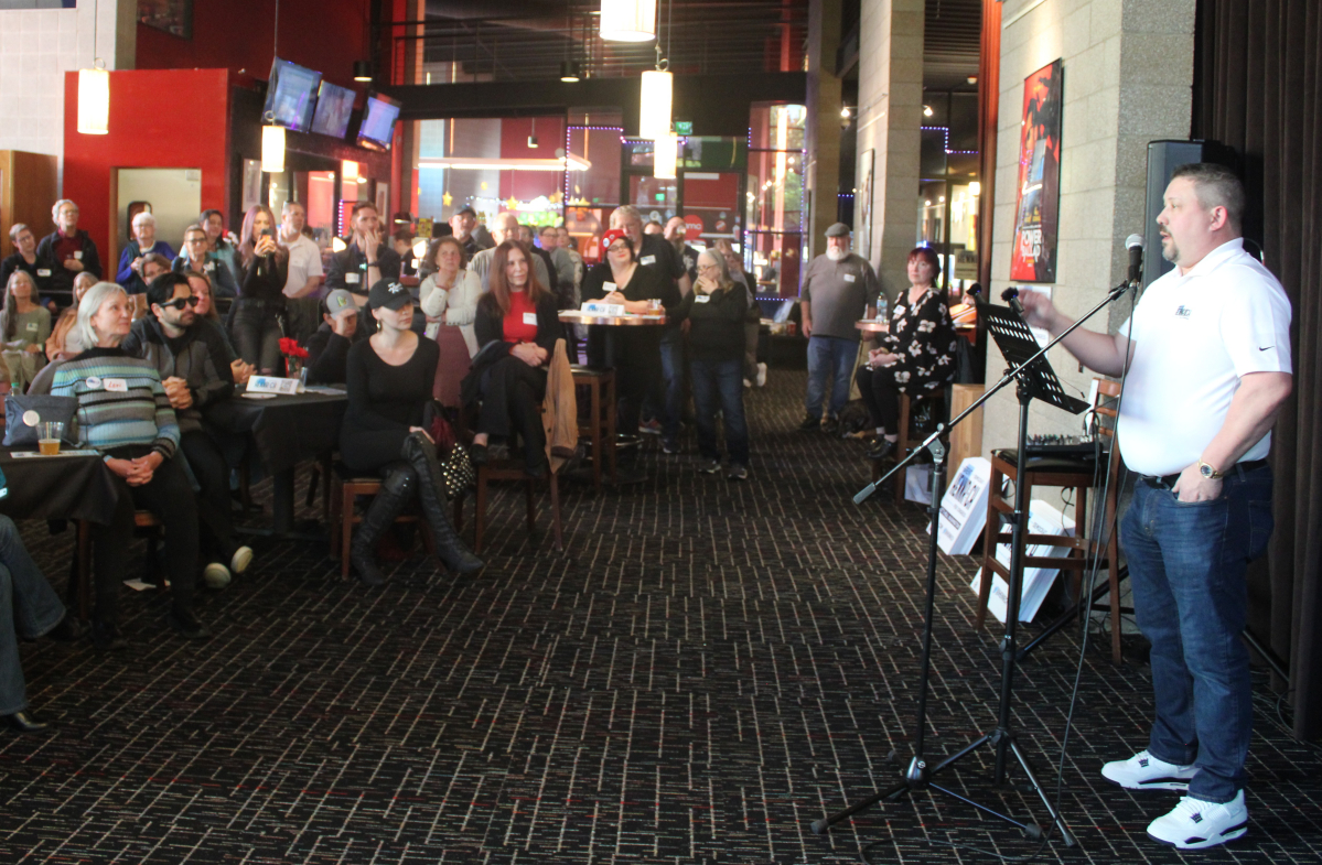 A crowd listens to Brent Hennrich, right, a Democratic candidate for Washington&rsquo;s 3rd Congressional District, during his campaign kickoff at the AMC Classic Mill Plain 8 cinema in Vancouver. (Kelly Moyer/The Columbian)