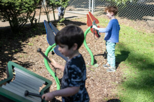 Preschoolers Erland Austad, right, and Marcus Ridge play in a sound garden Thursday morning at the Clark College child care center and lab school in the Child and Family Studies department. The child care center offers early learning education, while also being a crucial resource for student and employee parents, as well as the community.