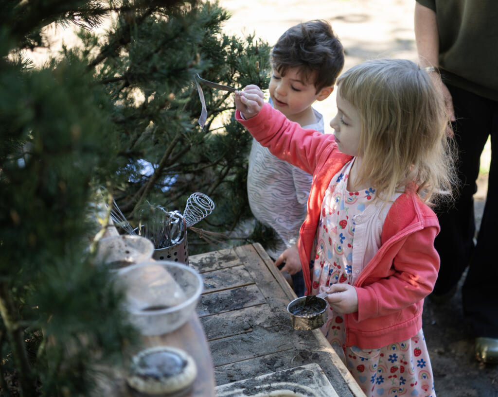 Preschoolers Juniper Phillips and Ace Evans play at a mud kitchen Thursday morning at the Clark College child care center and lab school in the Child and Family Studies area. &ldquo;I reached out and touched base with a couple of the parents that have their children enrolled here, and they said that we have been a really vital bridge in helping them achieve their academic goals,&rdquo; said Rose Witteveen, the Child and Family Studies director of educational services. (Taylor Balkom/The Columbian)