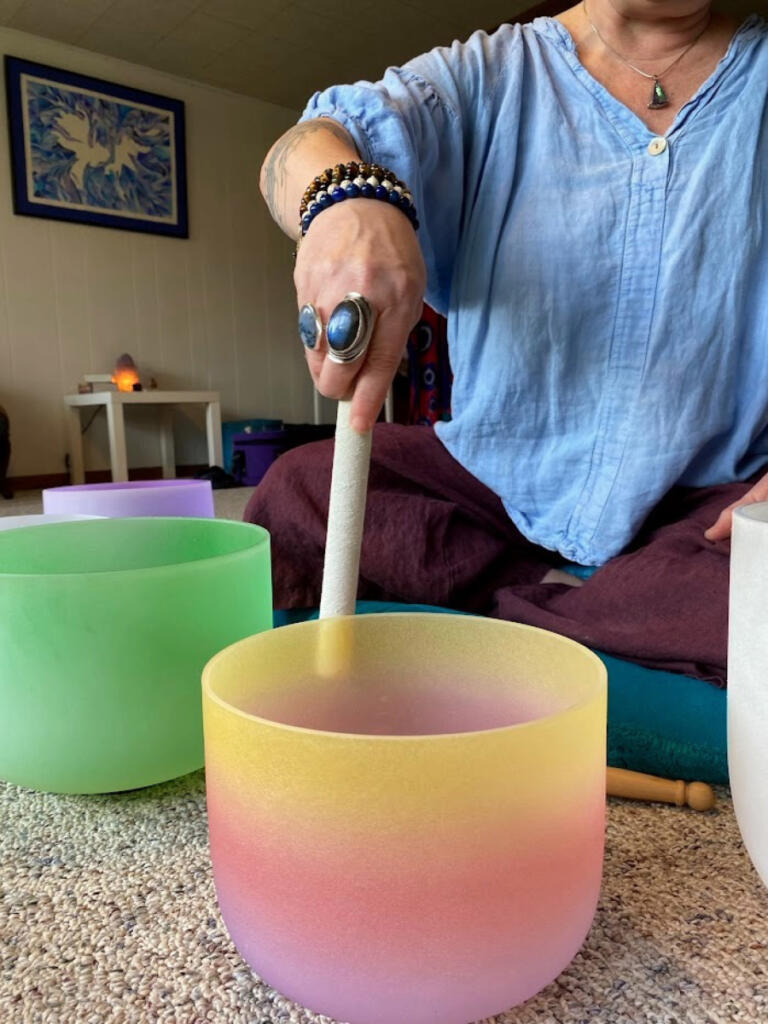 Rachel Fouts-Carrico plays one of her crystal singing bowls in her home studio. (Contributed photo)