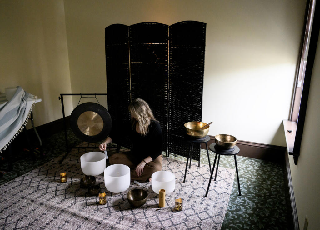 Andrea Kintzley demonstrates crystal singing bowls and other sound therapy instruments on March 10 at Soul Space Wellness in Vancouver. (Taylor Balkom/The Columbian)
