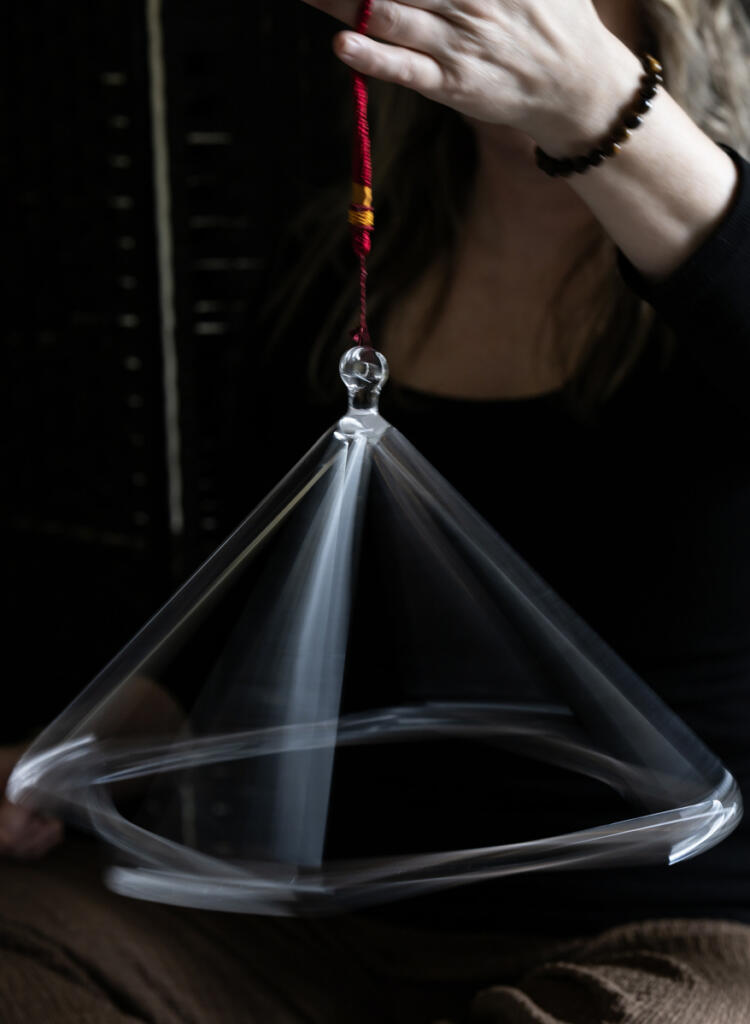 Andrea Kintzley demonstrates a crystal pyramid on March 10 at her Vancouver studio, Soul Space Wellness. The pyramid is rung with a mallet and then spun, spreading sound waves throughout the room. (Taylor Balkom/The Columbian)