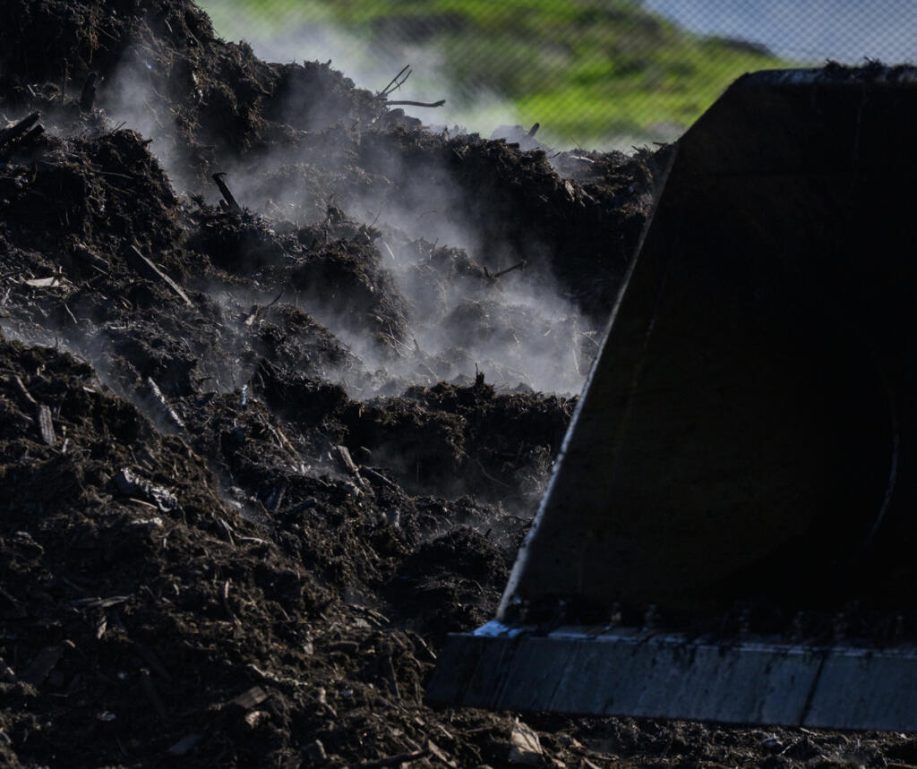 Steam rises from a pile of compost material March 20 at the Dirt Hugger composting facility in Dallesport. The company uses yard and food waste from Vancouver and Ridgefield to create compost sold at nurseries and landscape supply stores in Clark County. (Taylor Balkom/The Columbian)