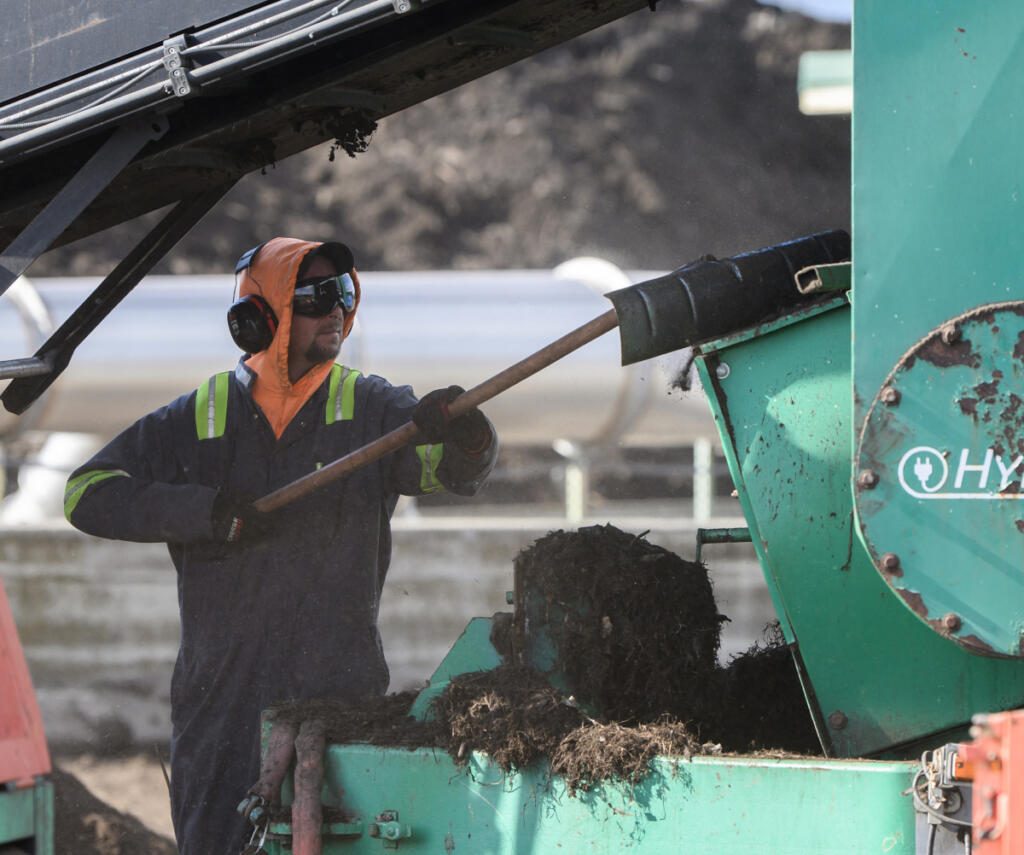 A worker cleans out a machine Friday at Dirt Hugger in Dallesport.
