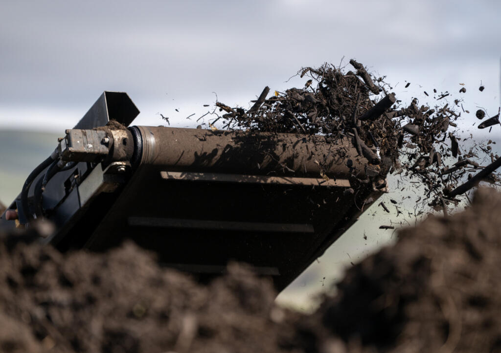 A conveyor belt moves compost material Friday at the Dirt Hugger composting facility in Dallesport.