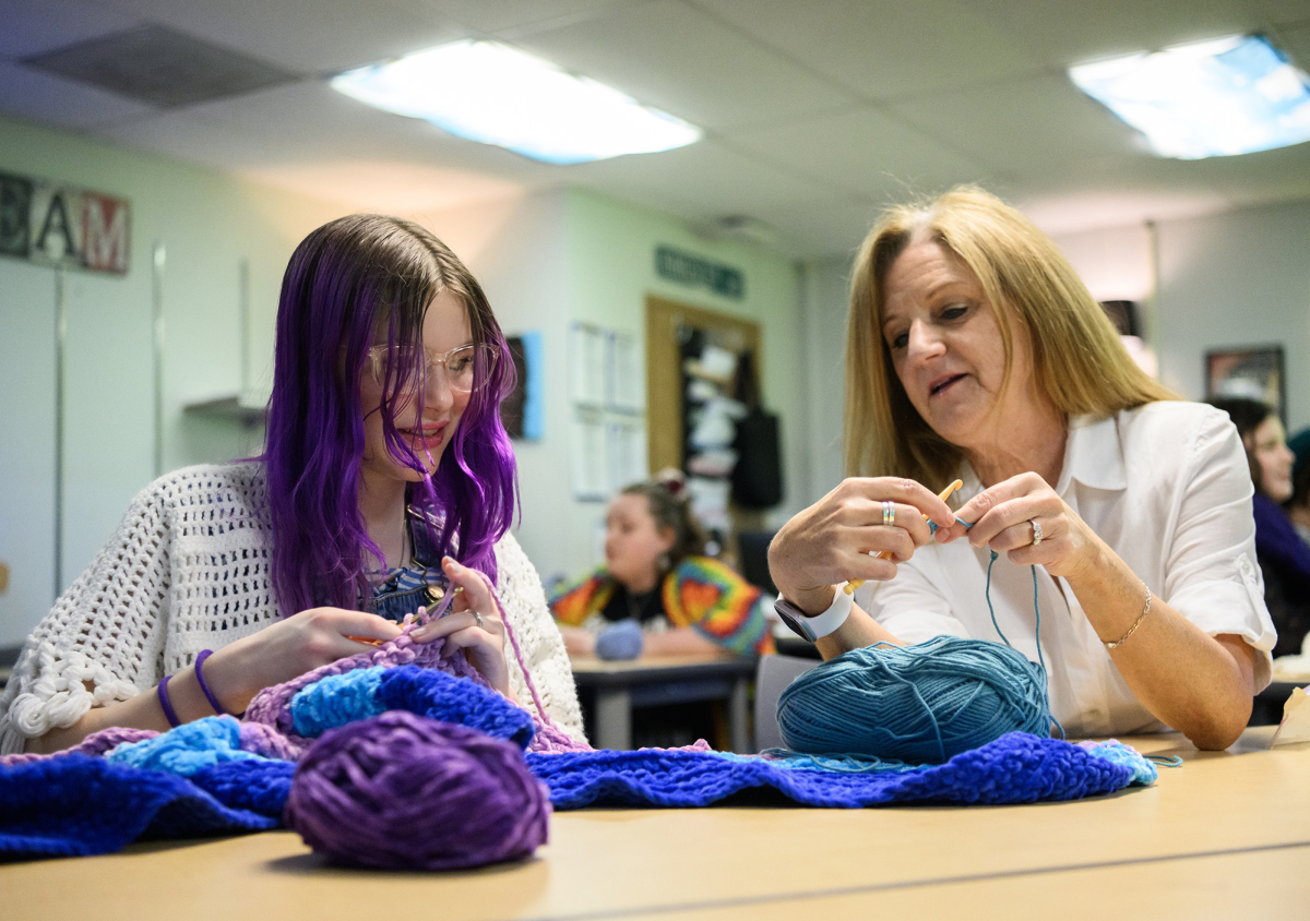 English teacher Ellie Kingsley, right, crochets with eighth-grader Millie Derheimer on March 24 during a crochet club meeting at Pacific Middle School. (Taylor Balkom/The Columbian)