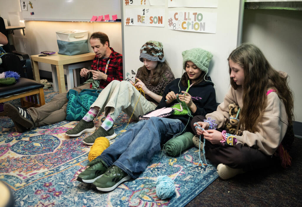 School nurse Ian Bader, from left, crochets with sixth-graders Sophia Goulding, Morgan Brumbaugh and Avery Baxter during a crochet club meeting at Pacific Middle School. (Photos by Taylor Balkom/The Columbian)