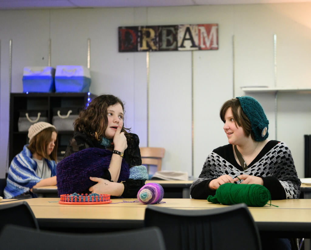 Sixth-graders Abigail Westman, left, and June Mathena chat during a crochet club meeting at Pacific Middle School. Mathena is one of three girls who petitioned the school to start a crochet club. (Taylor Balkom/The Columbian)