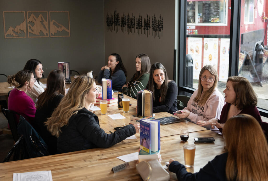 Romance Readers Social Club members chat about books April 1 at Ashwood Taps and Trucks in Washougal. (Taylor Balkom/The Columbian)