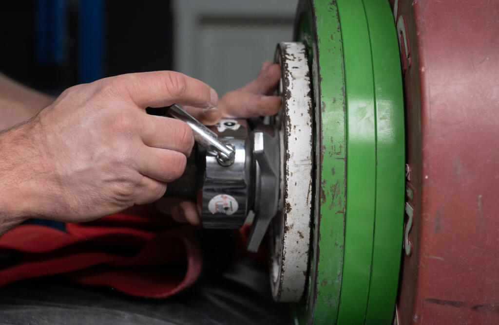 Camas resident Martins Licis adds more weight as he records a livestreaming workout for his followers at his home April 2. (Amanda Cowan/The Columbian)