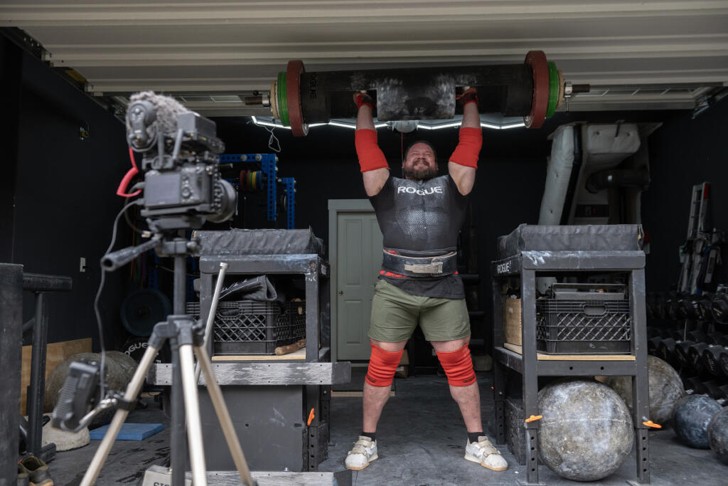 Camas resident Martins Licis, the Latvian-American strongman known worldwide as &ldquo;The Dragon,&rdquo; records a livestreaming workout lifting 432 pounds for his followers at his home April 2. Licis is set to return to the World&rsquo;s Strongest Man competition later this month, marking his first appearance since 2022. (Amanda Cowan/The Columbian)