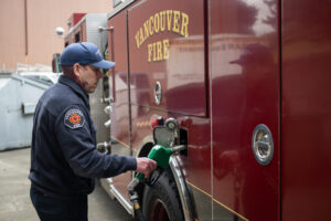 Firefighter Brenton Cooper refuels a rig Tuesday at the Vancouver Fire Department&rsquo;s Station 5 in Vancouver. (Taylor Balkom/The Columbian)