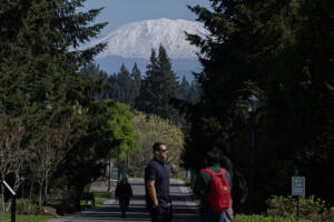 Students walk to classes Wednesday at Washington State University Vancouver, which enjoys a view of Mount St. Helens. The region is at 49 percent of average snowpack. (Amanda Cowan/The Columbian)