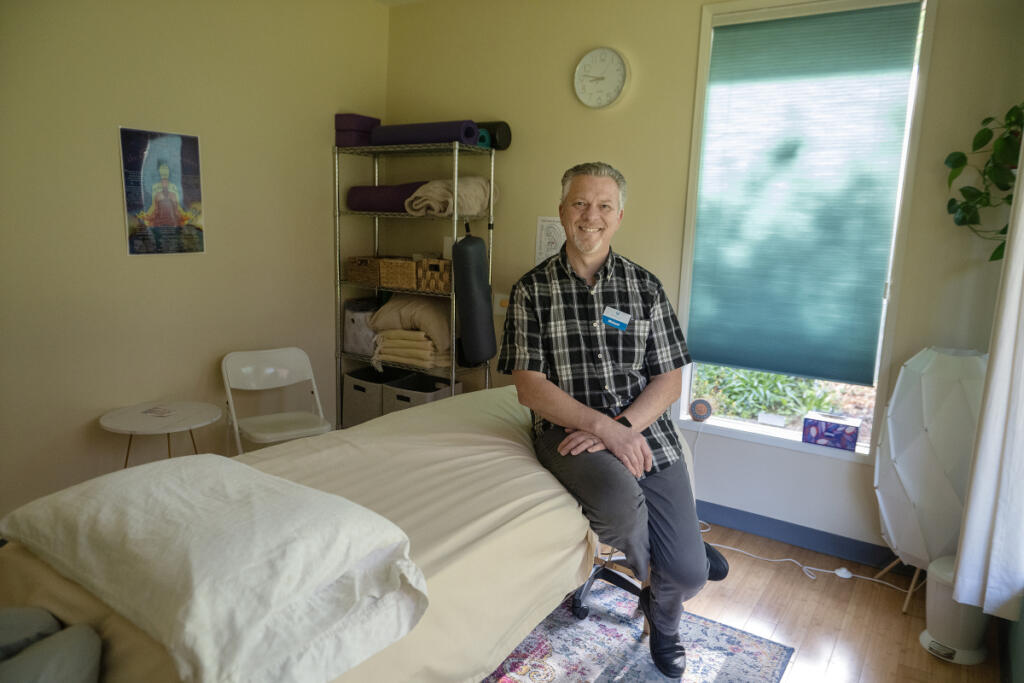 Michael Prevec, an acupuncturist at Ripple Wellness in Washougal, takes a break in a treatment room April 17. Prevec is a licensed acupuncturist specializing in the treatment of acute and chronic pain and peripheral neuropathy, headaches, dizziness/vertigo, fatigue, anxiety, depression, addiction, insomnia and allergies. (Photos by Amanda Cowan/The Columbian)